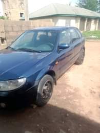 A picture of Mazda 323f Manual drive New baked on first body Tokunbo
