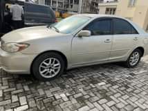 A picture of Toyota Camry 2004 First body but some parts painted Uber