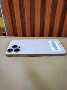 A picture of iPhone 13 pro max 256 GB gold 87 battery original